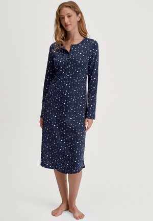 Nachtkleid in Marineblau mit langen Ärmeln, weißem Halbmond- und Punktmuster, knöpfbarem Ausschnitt und seitlichen Schlitzen für mehr Bewegungsfreiheit.