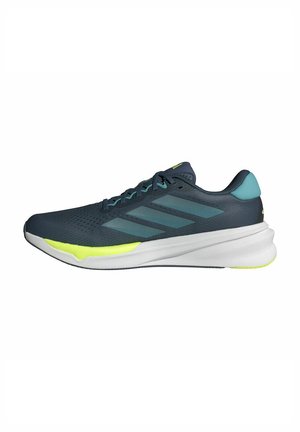 Dark blue athletic shoe with mesh upper, white sole, and neon yellow accents. Features three stripe logo and padded collar. Aerodynamic shape.