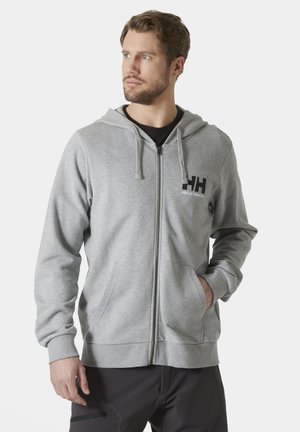 Szara bluza z kapturem na zamek, wykonana z miękkiego materiału, z kieszenią na przodzie, regulowanym kapturem oraz logo Helly Hansen na lewej stronie klatki piersiowej.