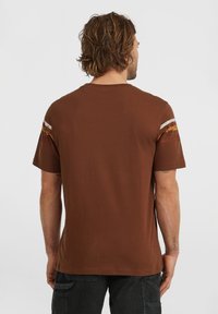 Brown short-sleeve t-shirt with simple design, featuring textured stripes in orange and white across the shoulders. Soft cotton fabric.