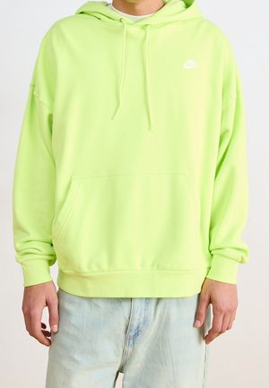 Neon groene oversized hoodie van zacht katoen, met een voorzak, trekkoord capuchon en een klein wit logo op de borst.