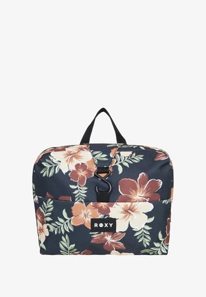 Floral backpack in navy with large beige and rust-colored flowers. Features a black strap handle and a front pocket with a logo patch.