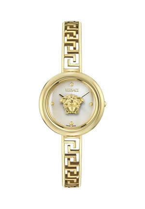 Złoty zegarek na rękę Versace z okrągłą białą tarczą, emblematem głowy Meduzy w centrum, złotymi geometrycznymi ogniwami bransolety oraz minimalistycznymi znacznikami godzin.