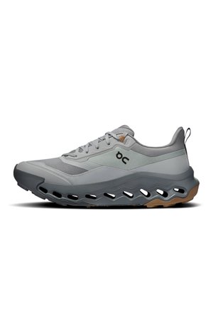 Gray athletic shoe features mesh and synthetic upper, lightweight design, distinctive cutouts in the sole, and a rubber outsole with traction.