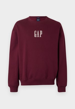 Bordeaux sweatshirt met een ronde hals, ribbel manchetten en zoom. Voorzien van een geborduurd 'GAP' logo in het wit aan de voorkant. Zachte, textuurstof.