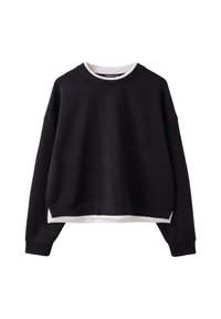 Sweat-shirt noir à col rond avec manches longues superposé sur une chemise blanche, présenté sur fond blanc.