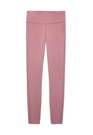 Kvinde iført matchende mauve højttaljede leggings og crop top med en mauve jakke delvist løftet over hendes torso.