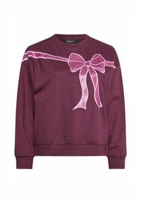 Ciemnofioletowa bluza z długim rękawem, z błyszczącą różową wstążką i kokardką na klatce piersiowej i ramionach.
