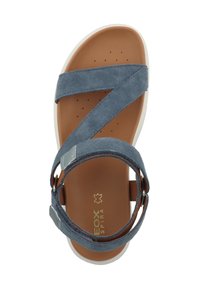 Blaue Wildleder-Sandale mit überkreuzten Riemen und verstellbarem Knöverschluss, ausgestattet mit einer braunen Innensohle und einer weißen Gummisohle.