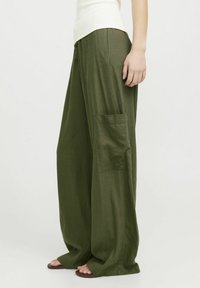 Pantalons amples de couleur verte olive en tissu léger, avec une poche latérale et une taille élastique pour le confort. Design à jambes larges.