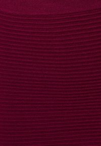 Bordeaux, ribbelstof met een gestructureerd patroon, geschikt voor kleding of accessoires; soepel en rekbaar materiaal.