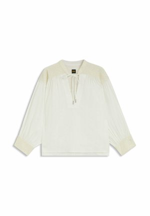 White blouse with embroidered cream accents, long sleeves, a v-neckline with ties, and gathered detailing at the shoulders and sleeves.
