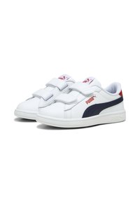 Baskets blanches avec des accents bleu marine, en matériau synthétique, avec deux bandes Velcro, bout rond et semelle en caoutchouc texturé. Marquage Puma sur le côté.