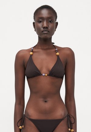 Brown bikini with triangular cups, adjustable ties, and beaded accents in yellow, purple, and orange. Soft fabric with minimal coverage.