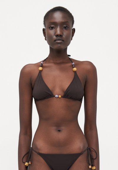Brown bikini with triangular cups, adjustable ties, and beaded accents in yellow, purple, and orange. Soft fabric with minimal coverage.