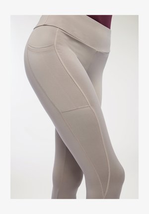 Leggings atletici beige con vita alta, tessuto morbido, cuciture piatte e dettagli in cucitura lungo le cosce per un look aderente.