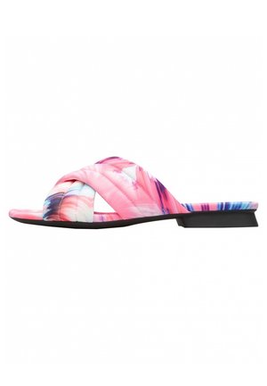 Qulited pink slide sandals with a crisscross strap design, featuring a colorful abstract pattern and a low black heel. Flat sole.