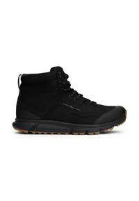 Botte de randonnée montante noire avec laçage à l'avant, col de cheville rembourré et semelle en gomme, avec le logo Tommy Hilfiger sur le côté.