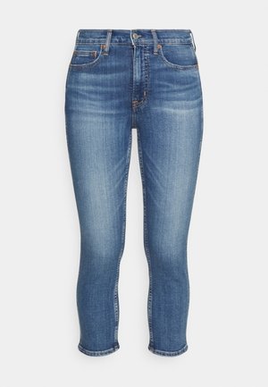 Blauwe denim skinny jeans met hoge taille, knoop- en ritssluiting aan de voorkant, vijf zakken en subtiele vervaagde details op de dijen.