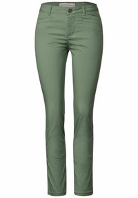Gröna, figurnära byxor i slätt tyg med medelhög midja, blixtlås och framfickor. Har en klassisk femficksdesign.