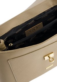 Beige textured leather handbag with a gold clasp, featuring a spacious black interior with multiple pockets and a branded label.