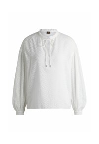 Blusa bianca a maniche lunghe con un motivo testurizzato, scollatura rotonda e chiusura a cravatta sul davanti; polsini elasticizzati e vestibilità rilassata.