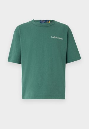 Green cotton t-shirt with a crew neck and short sleeves. Features a small white logo on the chest and a relaxed, boxy fit.