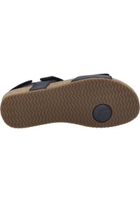 Zwarte sandalen met een textuur van kurken voetbed en rubberen zool. Voorzien van twee verstelbare banden met een zachte afwerking. Ronde logo-accent op de zool.