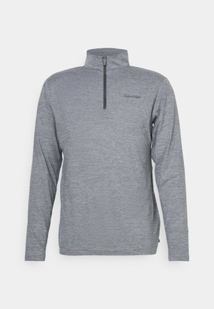 Grå pullover med hög krage och kort dragkedja. Har långa ärmar och subtilt texturerad tyg. Calvin Klein-logotypen tryckt på bröstet.