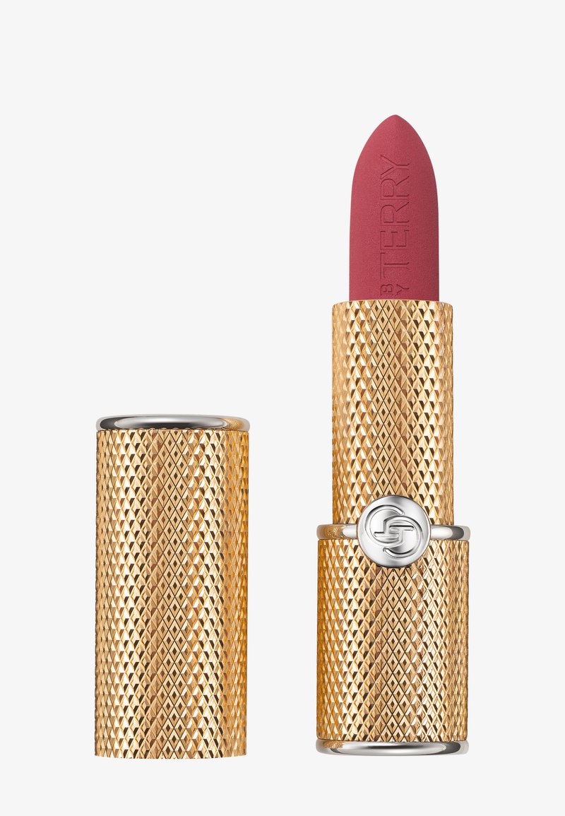 Rouge à lèvres avec un étui en or texturé comme un diamant. Bille matte rose avec le logo de la marque en relief. Accents en métal argenté sur le bouchon.