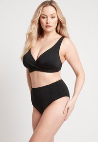 Czarny zestaw bikini z dekoltem w literę V i wysokim stanem. Góra ma skręcony przód i szerokie ramiączka; dół posiada boczne marszczenie.