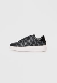 Black sneakers featuring a houndstooth pattern, smooth leather details, black laces, and a white sole with subtle branding on the side.