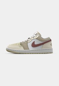 Beige leather sneaker with white and light tan accents, featuring a maroon Nike swoosh, perforated toe, and white laces.