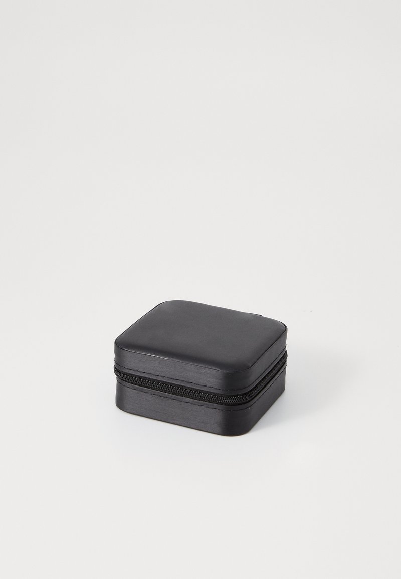 Black square storage case with a smooth surface, zip closure, and rounded corners. Compact design suitable for various small items.