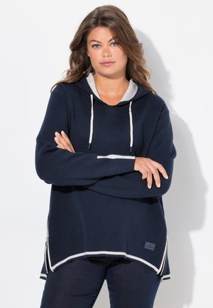 Marineblauwe hoodie met een lichtgrijze voering, voorzien van witte accenten, aantrekkoorden en zijritsen. Zachte, geborstelde stof.