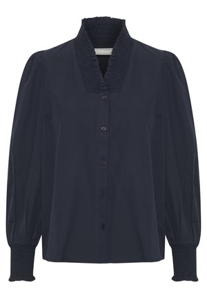 Námornícka modrá košeľa na gombíky so smockovaným golierom, dlhými vyp puff rukávmi a smockovanými manžetami. Vyrobená z hladkého materiálu so štruktúrovaným dizajnom.