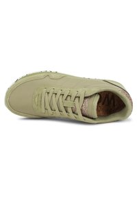Green leather sneaker with a textured cork insole, low profile, lace-up front, and a rubber sole. Notable for its minimalist design.