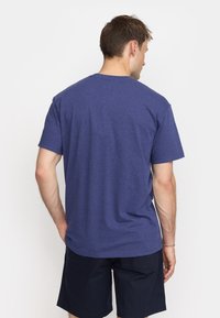 Navy blue, short-sleeve t-shirt with a crew neckline, made of textured fabric, gently fitted body. Casual design suitable for everyday wear.