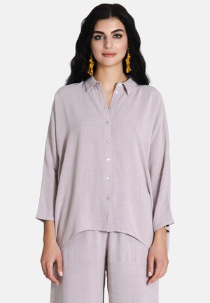 Light gray, button-up blouse with a relaxed fit, collar, and three-quarter sleeves. Soft texture with a curved hemline.