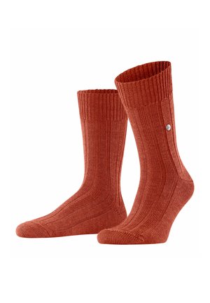 Ribbed, mid-calf socks in a warm terracotta color. Made of soft fabric with a fitted design and a small logo detail on the side.