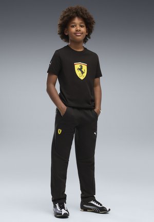 Puma, FERRARI TRAININGSHOSE UNISEX - Træningsbukser - black