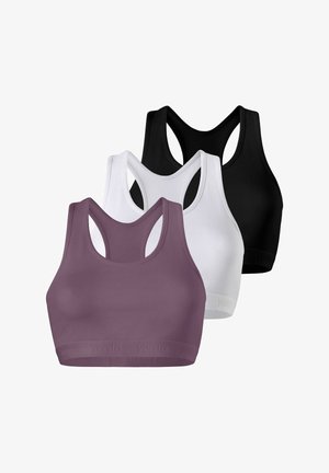 Frau mit mauvefarbenem Sport-BH mit "yentia"-Logo, glatten dunklen Haaren, neutralem Gesichtsausdruck, vor einfachem hellem Hintergrund.