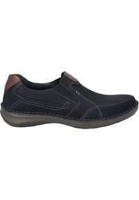 Men's slip-on shoes featuring a navy suede upper, brown leather accents, beige stitching, and a flexible rubber sole.
