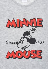 Camiseta de algodón gris con un gráfico de Minnie Mouse en blanco y negro, con texto rojo que dice "MINNIE MOUSE Desde 1928."
