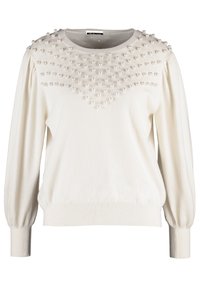 Maglione bianco con scollo rotondo, corpo testurizzato con dettagli in rilievo simili a perle e maniche lunghe a sbuffo. Polsini e orlo a coste.