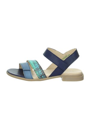 Blue and navy sandal with two wide straps, a textured iridescent center panel, and a low clear heel. Soft leather and rubber materials.