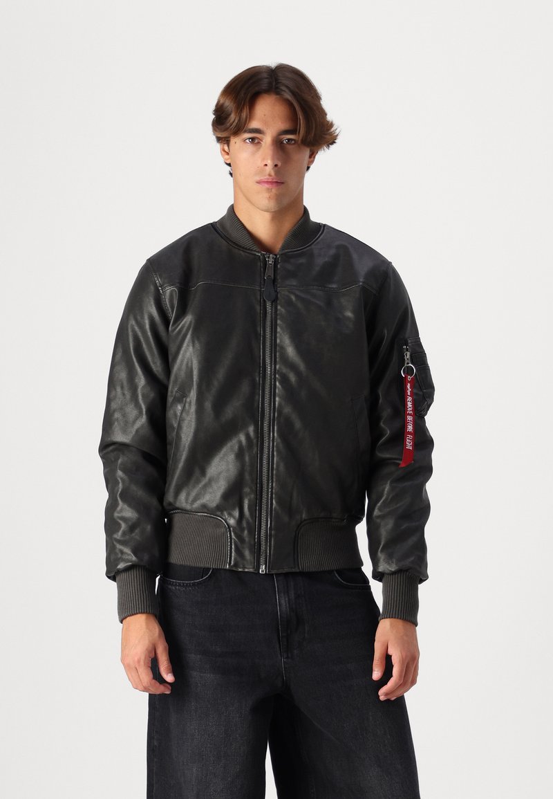 Black leather bomber jacket with ribbed cuffs and hem, featuring a front zipper and a side pocket with a red keychain accent.