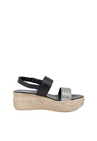 Sandali wedges neri con suola in espadrille testurizzata, caratterizzati da una ampia fascia decorata con strass e una cinghia regolabile alla caviglia.