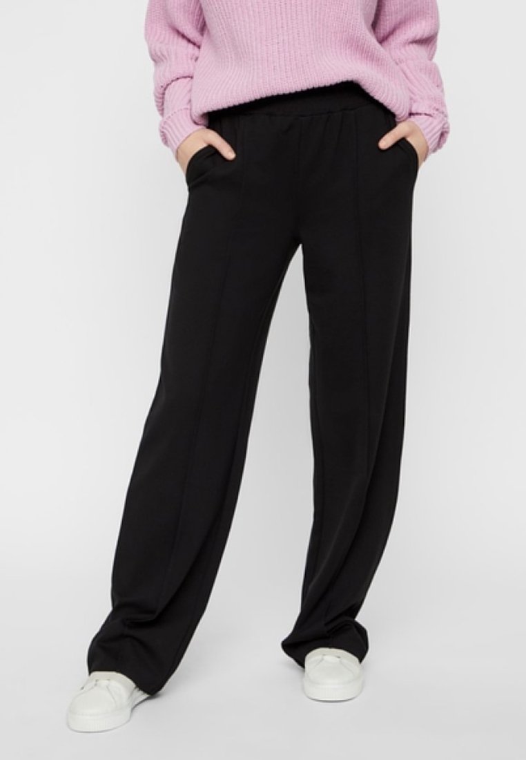 Black wide-leg trousers with a smooth texture, featuring side pockets and an elastic waistband, paired with white sneakers.