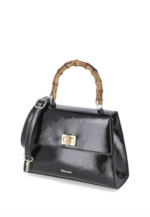 Glänzende schwarze Handtasche mit bambusartigem, festem Griff, goldfarbenem Verschluss und verstellbarem Schulterriemen auf weißem Hintergrund.